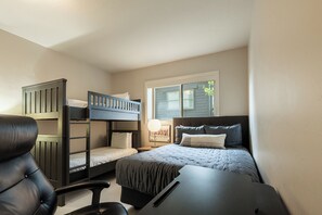 A bedroom with bunk beds, a desk, and a chair. - 5BR Park City retreat with hot tub, fireplace, mountain views. (Park City)