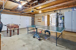 A ping pong table in a room with a wooden ceiling and a water heater. - Nestle Inn-direct beach access, views, best spot in town. (Neskowin)
