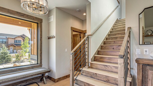 A staircase with wooden steps and metal railings, leading to an upper floor. - Granby Mtn Retreat w/ Ski Hill Views, Hot Tub (Granby)