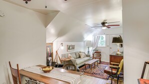 A cozy loft-style living space with a dining area, a sofa, and a ceiling fan. - Walk to Downtown Chico! Tree-Lined Apt w/ Deck (Chico)
