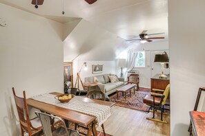 A cozy loft-style living space with a dining area, a sofa, and a ceiling fan. - Walk to Downtown Chico! Tree-Lined Apt w/ Deck (Chico)