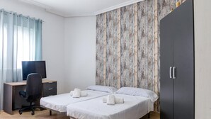 A hotel room with two beds, a desk with a computer, and a wardrobe. - Lovely home in Pechina (Pechina)