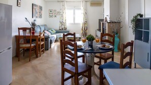 A dining area with a table, chairs, and a sofa. - Lovely home in Pechina (Pechina)