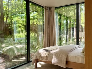 Room - Reconnect at this magical, ultra-modern Catskills mirror cabin. Features a plush queen bed, sleek kitchenette, and dramatic forest views. Explore 140 pristine acres with scenic trout streams and a breathtaking 30ft waterfall. (Palenville)