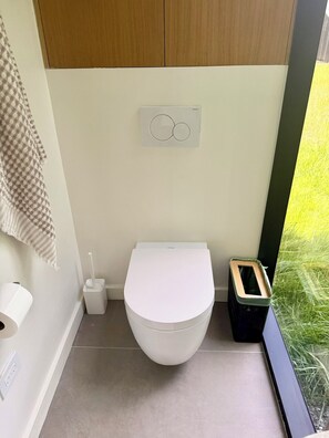 Bathroom - Reconnect at this magical, ultra-modern Catskills mirror cabin. Features a plush queen bed, sleek kitchenette, and dramatic forest views. Explore 140 pristine acres with scenic trout streams and a breathtaking 30ft waterfall. (Palenville)