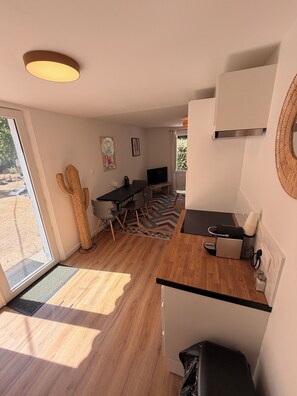 A compact kitchen with a dining area, a cactus decoration, and a large window. - MAISON HORTENSE: Sleeps 8, 3 minutes from the beach and downtown (Saint-Brevin-les-Pins)