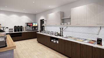 A modern kitchen with a long counter, coffee machines, and a juice dispenser.
