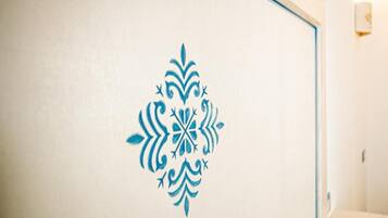 A wall with a decorative blue pattern.