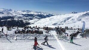 A snowy ski slope with skiers and snowboarders, a ski lift, and a mountain backdrop. - Casa Mira Selva, (Flims Dorf), by Interhome (Flims)