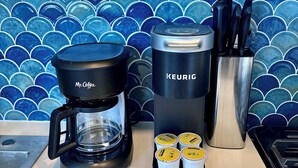 Eine Kaffeemaschine, eine Keurig und Kaffeekapseln auf einer Küchenarbeitsplatte.