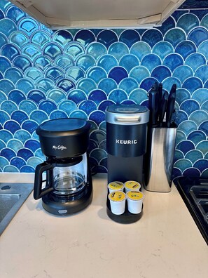 A coffee maker, a Keurig, and coffee pods on a kitchen counter. - Luxury Downtown Studio • 2 Blocks to the Square (Prescott)