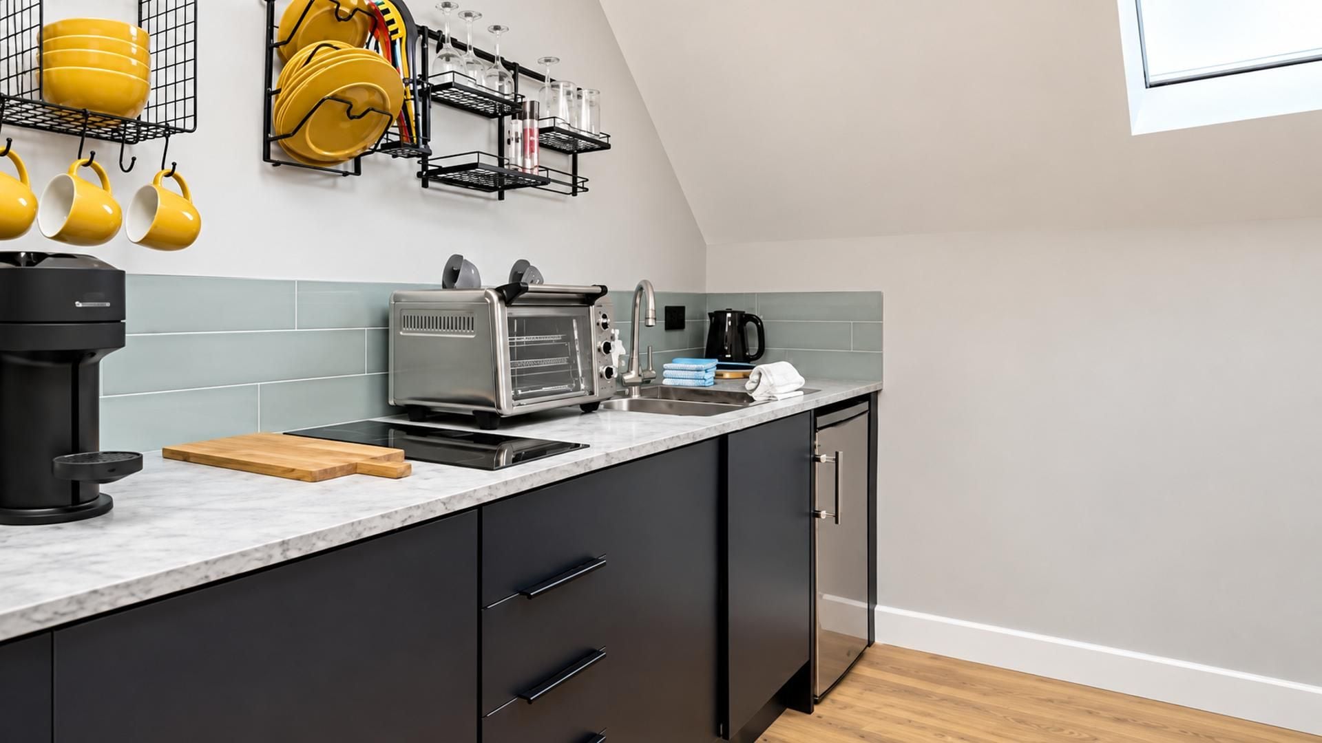 A modern kitchen with a built-in oven, a coffee maker, and a toaster.