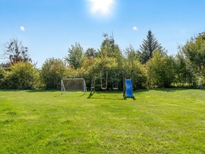 A grassy field with a soccer goal, swings, and a slide. - "Christiern" - 600m from the sea by Interhome (Bindslev)