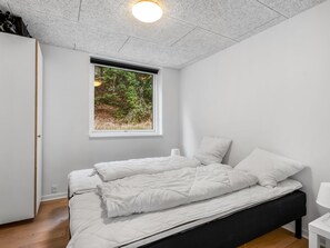 A bedroom with a bed, a window, and a ceiling light. - "Adisl" - 800m from the sea by Interhome (Hadsund)