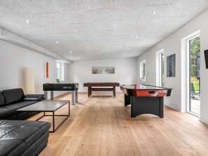 A spacious living area with a foosball table, a pool table, a sofa, and a coffee table. - "Adisl" - 800m from the sea by Interhome (Hadsund)