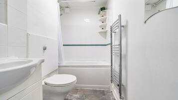 Separate bathtub and shower, deep-soaking bathtub, hair dryer, towels