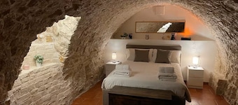 Grotta Paradiso, a two-story stone cottage with a warm and cozy charm.