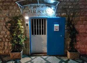 Exterior detail - Grotta Paradiso, a two-story stone cottage with a warm and cozy charm. (Molfetta)