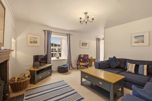 Comfortable lounge with open fireplace, Smart TV and generous corner sofa - Millhouse Cottage - North East Escapes (Waren Mill)