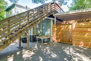 A wooden staircase leading to a garage with a closed wooden door and a 'DRUG FREE ZONE' sign.