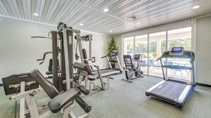 A gym with exercise equipment, a treadmill, and a large window with a view. - Gorgeous Ground Floor Condo Just Steps to Pool! (Calabash)