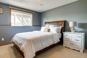 A bedroom with a bed, nightstand, and lamp.