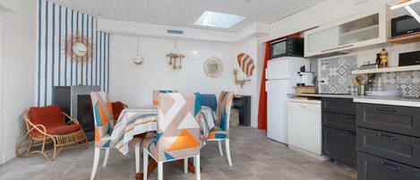 A compact kitchen with white cabinets, a microwave, and a dishwasher.