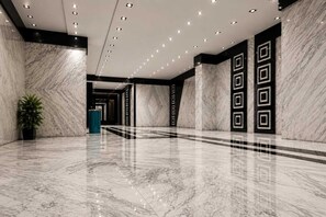 A spacious lobby with marble flooring, recessed lighting, and geometric wall designs. - Grand Pyramids Hotel (Giza)