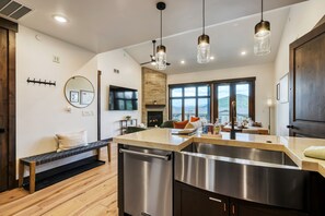 A modern kitchen with a stainless steel sink, a built-in dishwasher, and pendant lights. - Pool Hot Tub And Luxury Living At Blackstone 3k 2 Bedroom Condo (Park City)