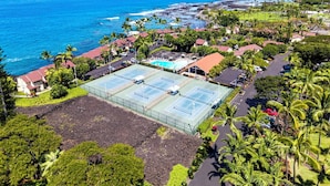 A coastal residential area with a tennis court, houses, and a view of the ocean. - Kksr#1301 Direct Oceanfront, Best North Corner Top Floor Location (KAILUA KONA)