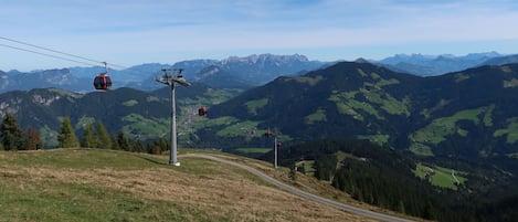 A cable car system in a mountainous area with a clear sky.