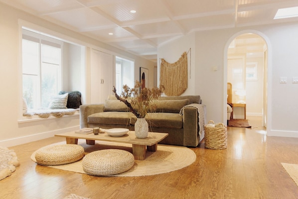 A living room with a sofa, coffee table, and decorative items.