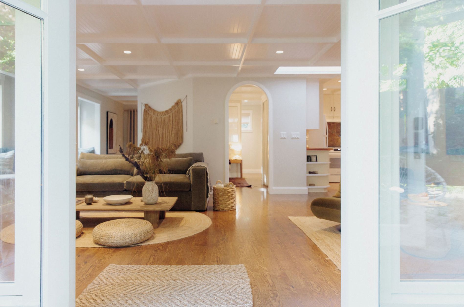 A modern living room with a sofa, coffee table, and decorative items.