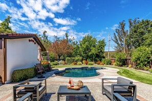 A backyard with a swimming pool, patio furniture, and a small building labeled 'DOME.'