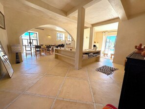 A spacious interior with an open-plan layout, a kitchen area, and a dining space. - GOLDA HOUSE, Essaouira, Heated Pool, Stove (Essaouira)