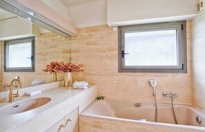 A bathroom with a large bathtub, a double sink, a mirror, and a window. - Charming Apt w/ Large Balcony - 2bd/4p -deauville (Deauville)