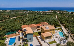 A residential area with multiple houses, a swimming pool, and a view of the sea. - Kaletzia Villa IV - Four Bedroom Villa, Sleeps 8 (Zakinthos)