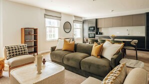 A modern living room with a sofa set, a coffee table, and a bookshelf. - Premium 3-Bed Belgravia | Sloane Square (London)