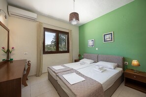 A bedroom with a bed, a desk, a window, and a green wall. - Villa Lemonia - Two Bedroom Villa, Sleeps 4 (Platanias)