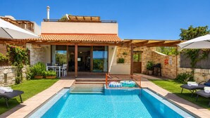 A modern house with a swimming pool, outdoor seating, and a view of the landscape. - Villa Mandarin - Two Bedroom Villa, Sleeps 4 (Platanias)