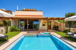 A modern house with a swimming pool, outdoor seating, and a view of the landscape. - Villa Mandarin - Two Bedroom Villa, Sleeps 4 (Platanias)