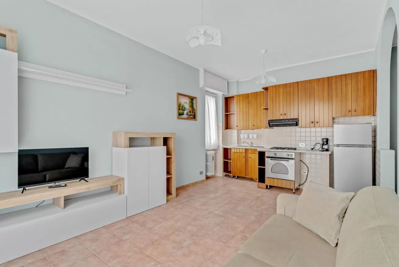 Un appartamento moderno con un soggiorno, una cucina e una zona pranzo.