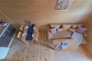 A wooden interior with a dining table and chairs, a sofa, and a small coffee table. - Holiday home with a terrace, close to the sea (Sianozety)