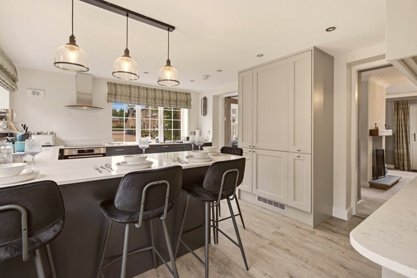 Spacious kitchen island with breakfast seating and contemporary pendant lighting