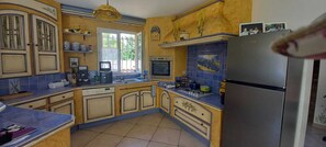 A kitchen with a refrigerator, stove, sink, and various appliances. - Air-conditioned Provençal villa with a pool (8 m x 4 m)—a haven of peace.... (Ventabren)