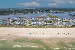 An aerial view of a coastal residential area with houses, a beach, and a marina. - Canal Views, Saltwater Pool, Private Elevator (Carolina Beach)