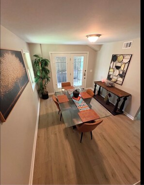 A dining area with a glass-top table, brown chairs, and a patterned runner. - 6 ACRES RETREAT SAUNA, HOT TUB, FIRE PIT, GAMES (Jasper)