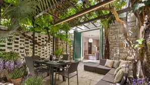 An outdoor patio area with a dining table, chairs, and a sofa set. - Garden Apartment Orange I Porec Old Town (Porec)