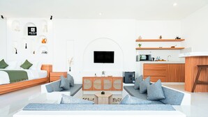 A modern living room with a sofa, coffee table, and a TV mounted on the wall. - Dita Villa Uluwatu (Uluwatu)
