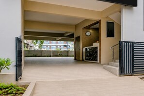 An entrance area with a flat roof, a clock, and a staircase leading to an upper level. - Hotel O Visakhapatnam Railway Junction (Visakhapatnam)